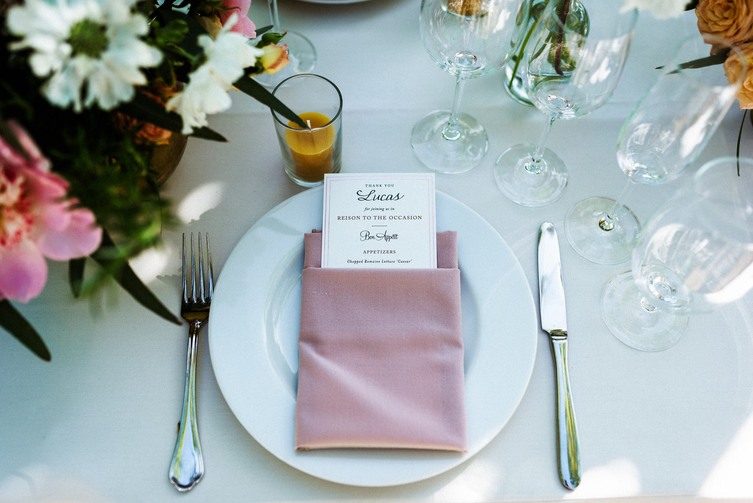 Place setting with a blush napkin and hand-lettered menu card