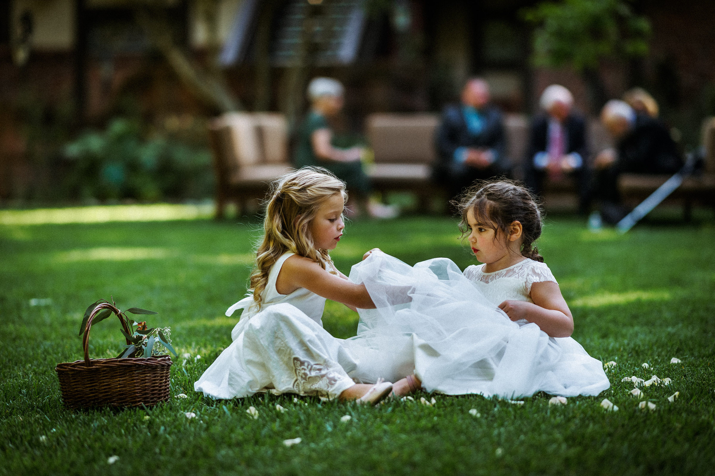 Two flower girls playing on the lawn before the reception