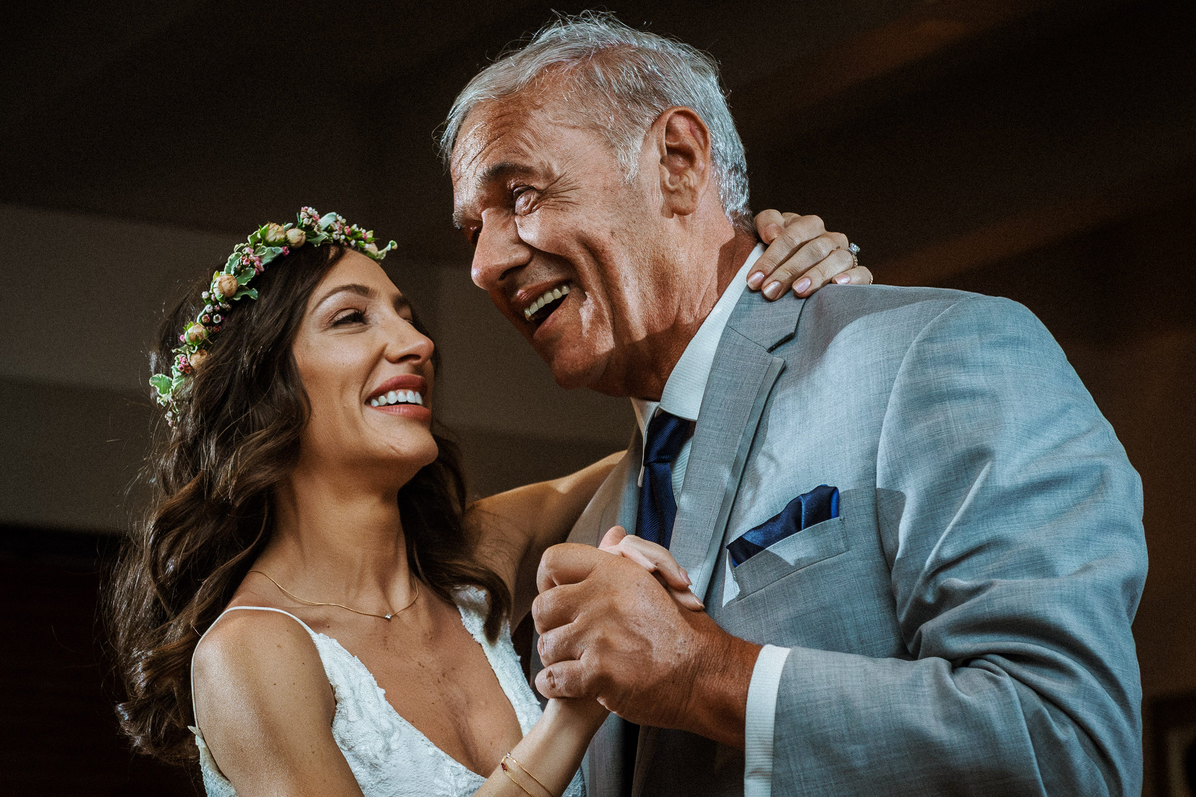 Bride dancing with her father inside the reception room