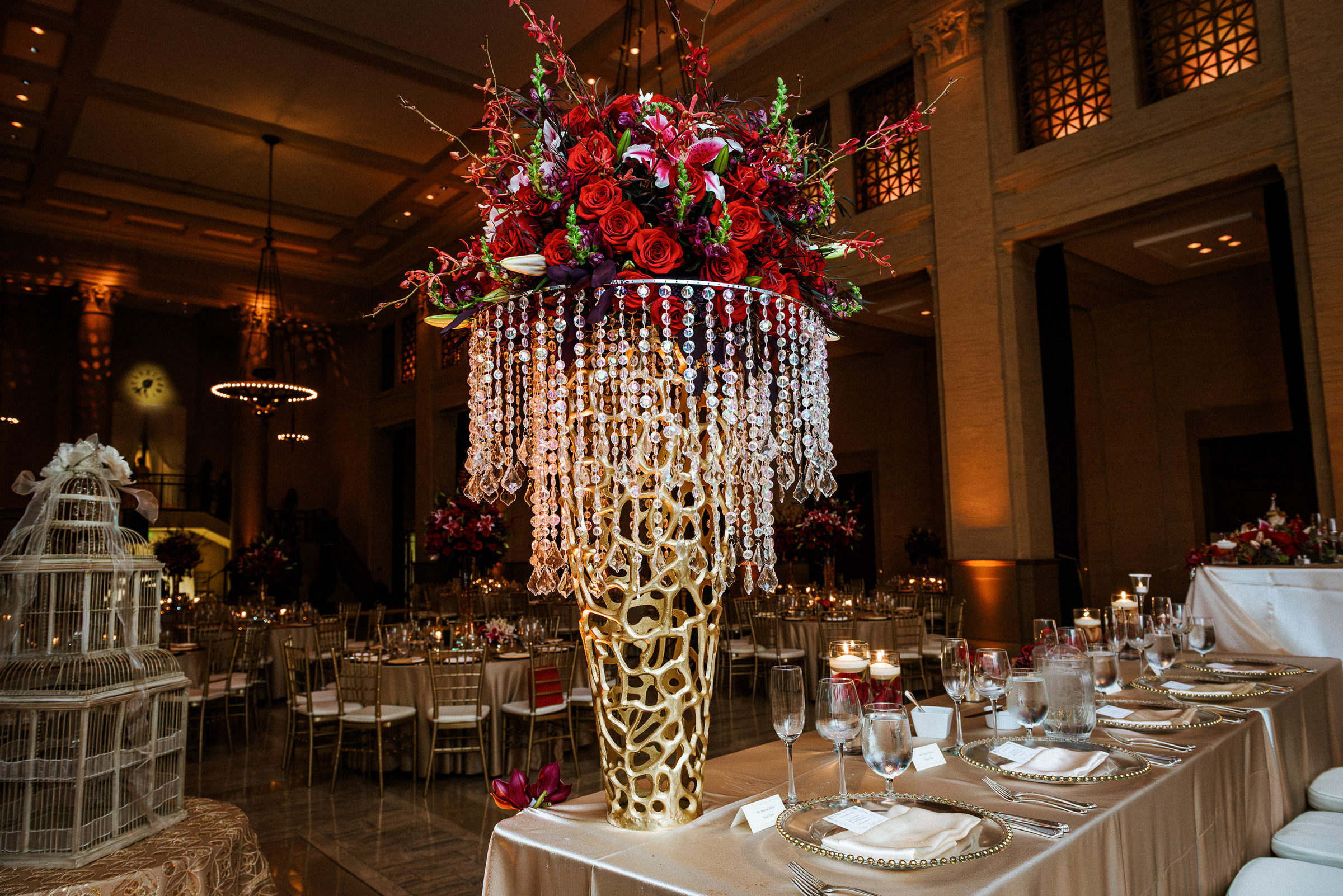Towering red rose centerpiece above a head table at the Bently Reserve