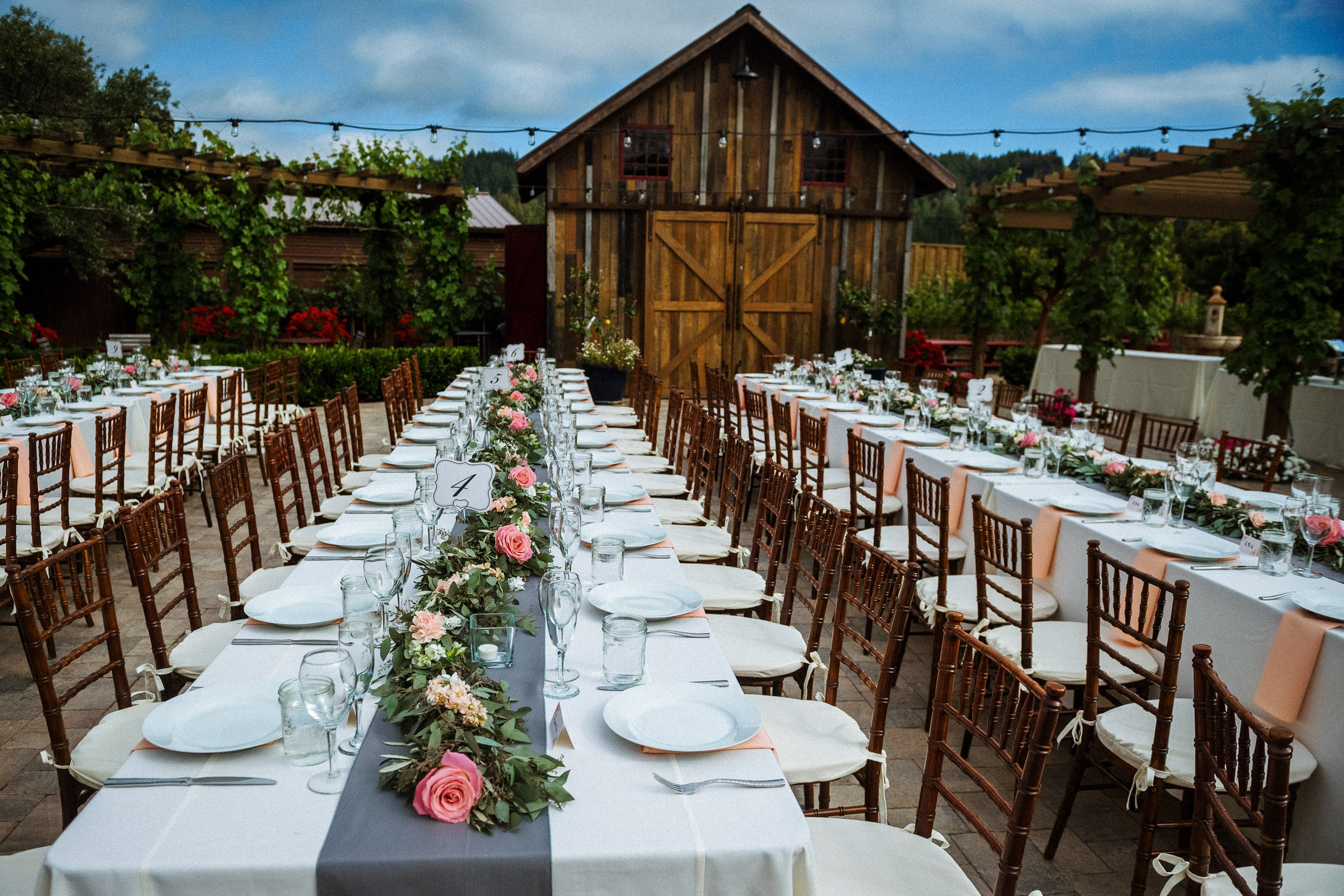 Long tables set for dinner beneath the barn at Regale Winery