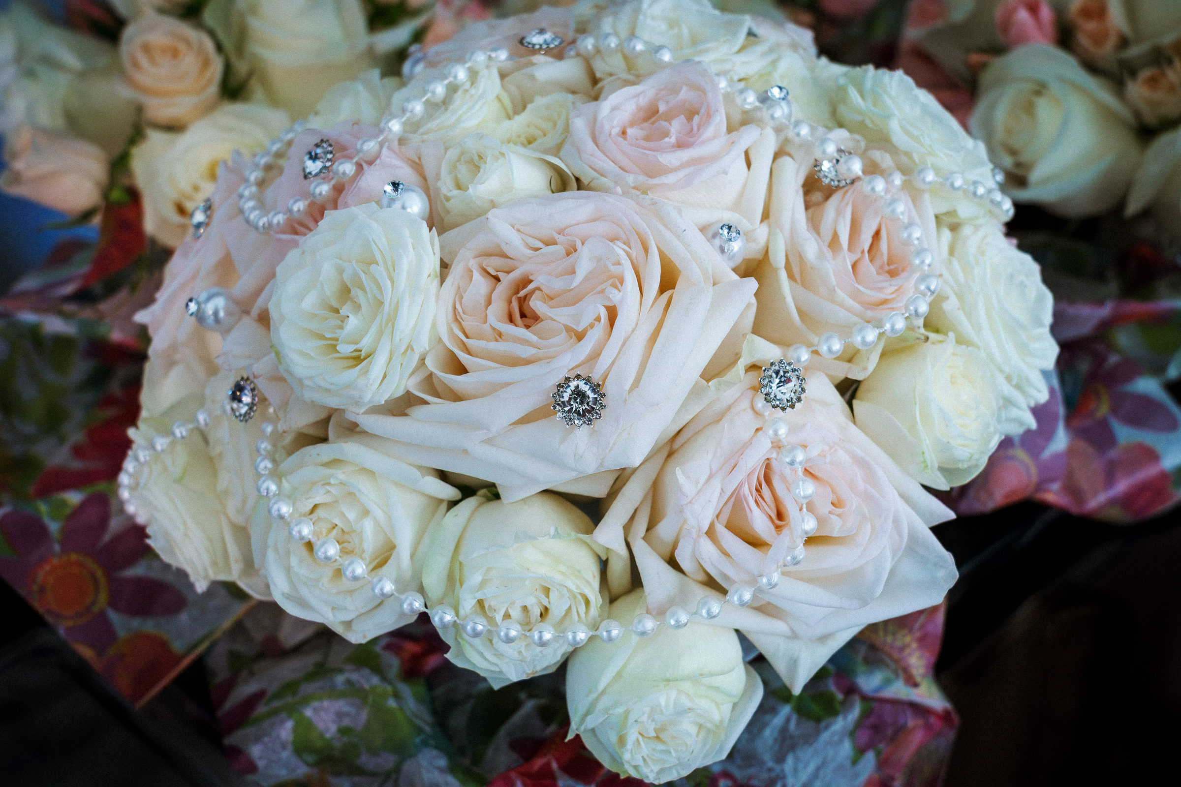 Bridal bouquet of cream roses strung with pearls and crystal brooches