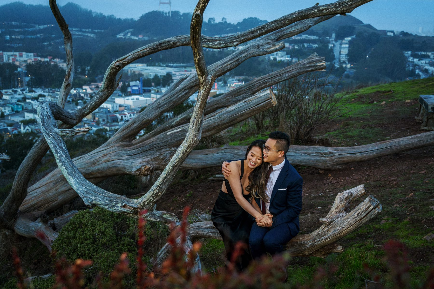Engaged couple sharing a quiet moment on a scenic San Francisco hillside