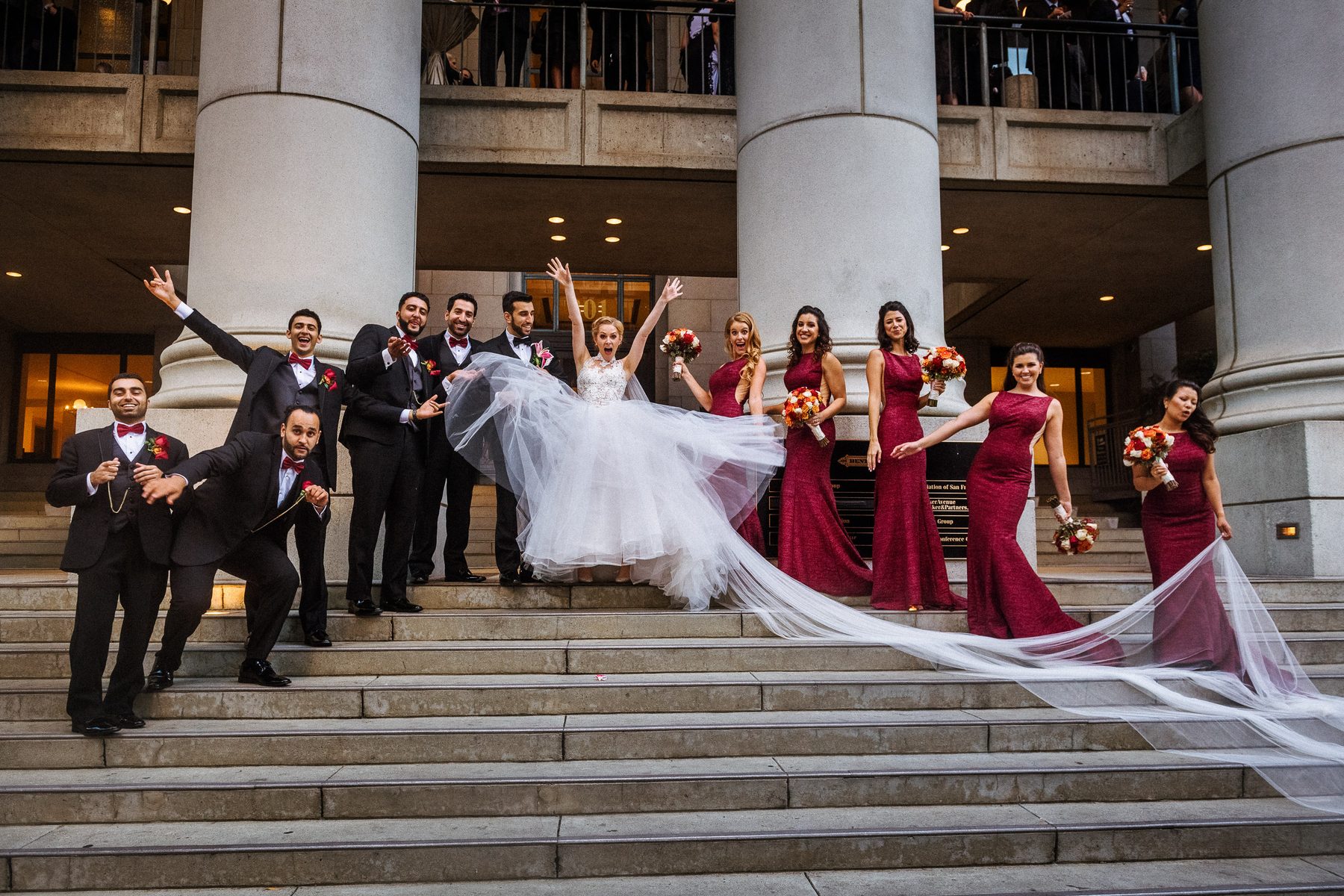 Bride, groom and wedding party celebrating outside the Bently Reserve in San Francisco