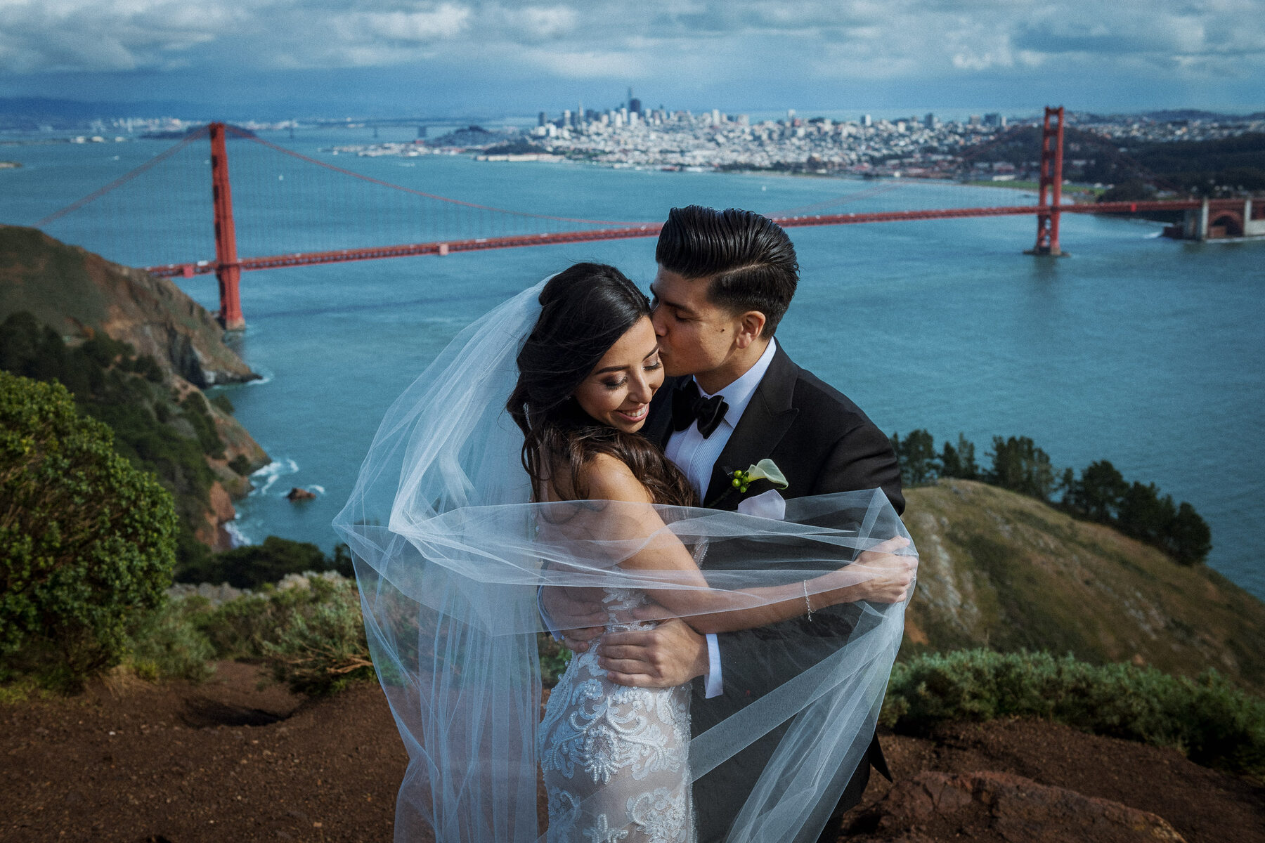 Bride and groom overlooking the Golden Gate Bridge from the Marin Headlands