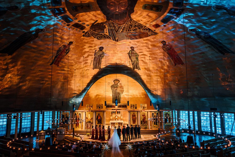 Bride walking down the aisle during an ornate San Francisco church wedding ceremony