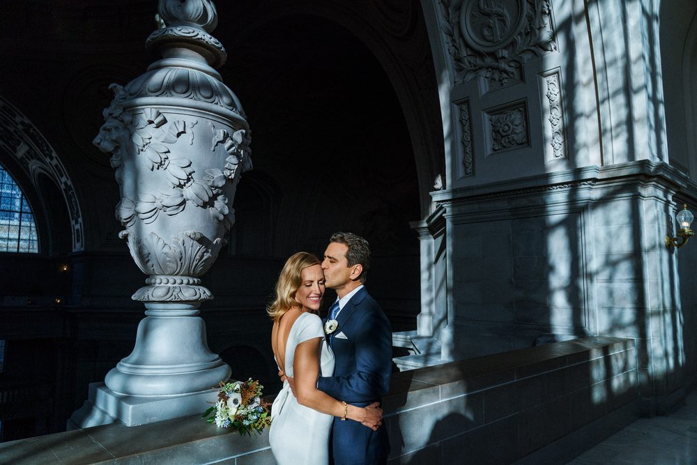 San Francisco City Hall wedding portrait of a bride and groom beneath grand architecture