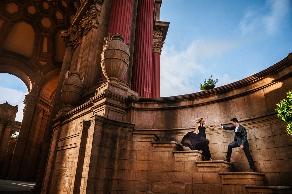 Bride and groom beneath the classical arches of the Palace of Fine Arts in San Francisco