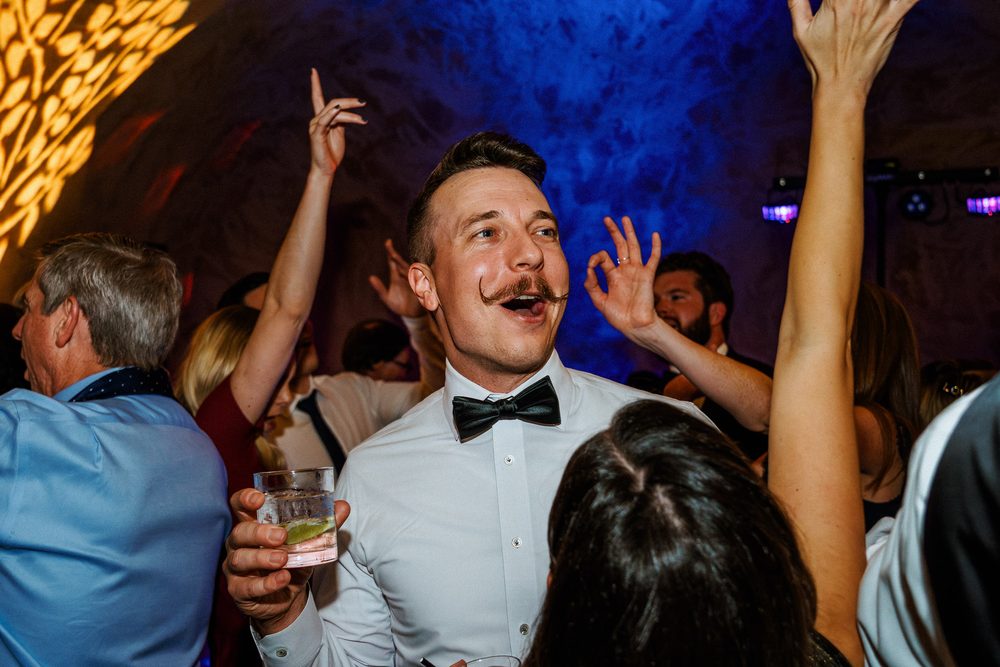 Groom dancing with guests during a lively Napa Valley wedding reception