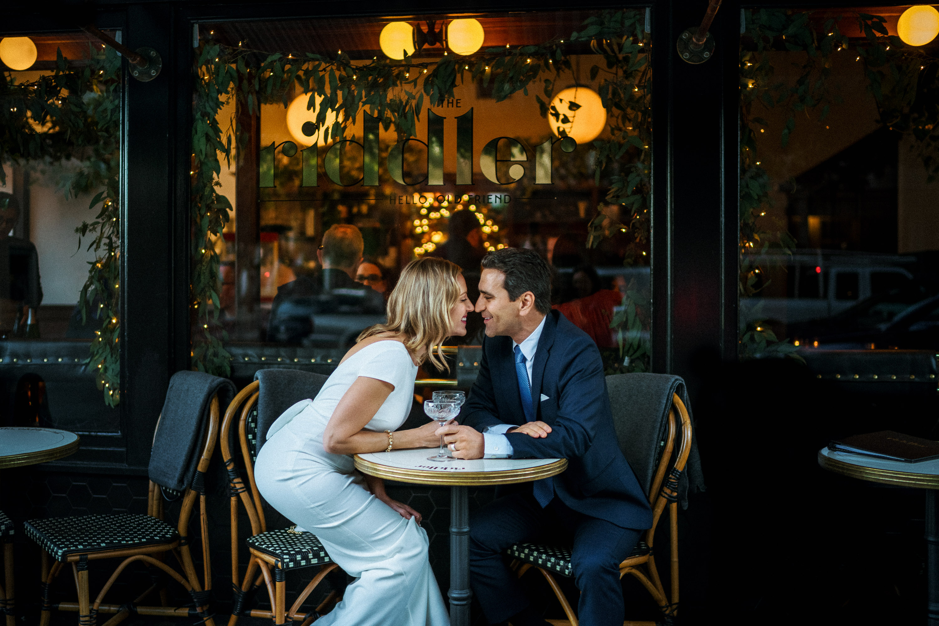 Newlyweds celebrating at a champagne bar after their San Francisco City Hall wedding