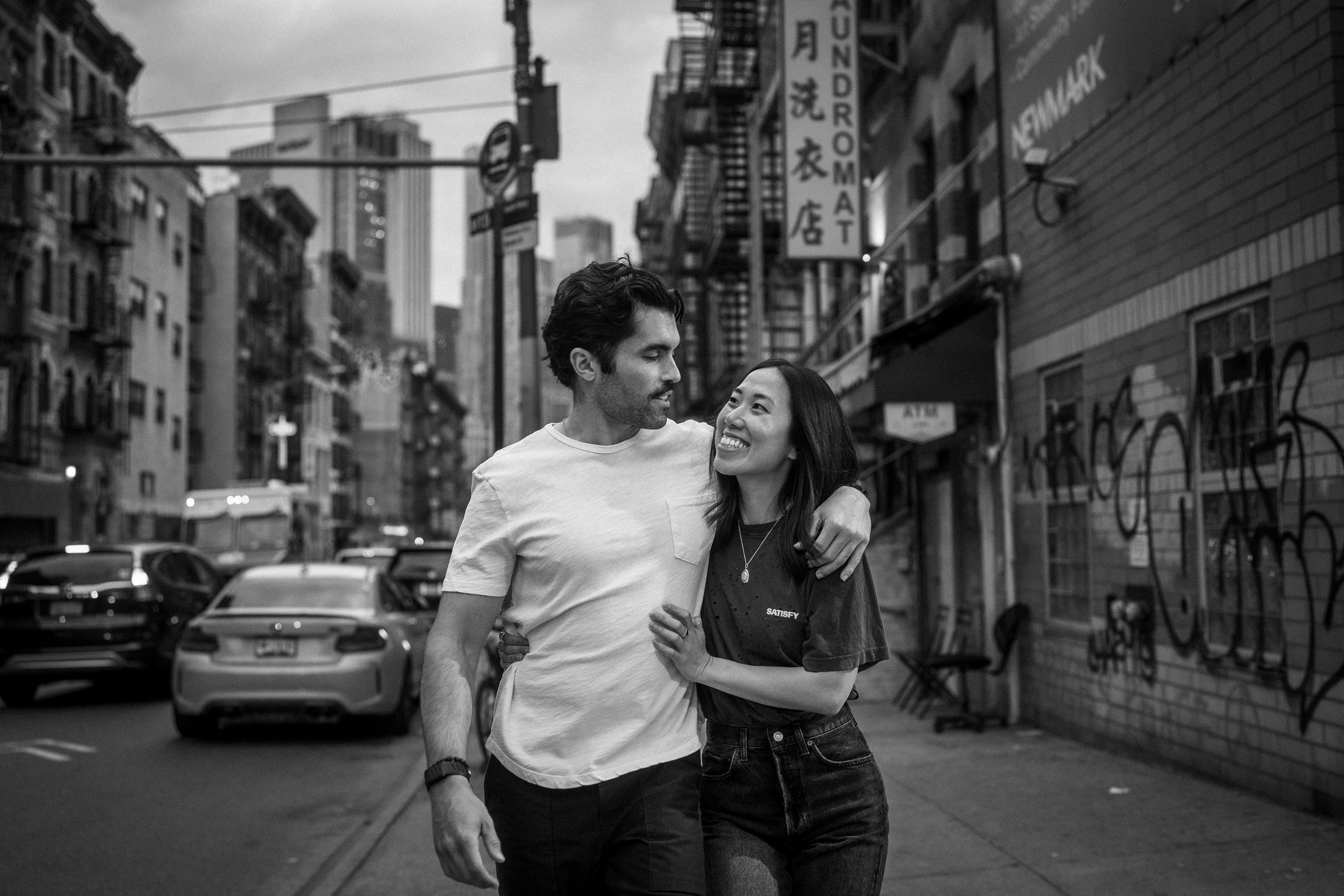 Engaged couple walking together through Chinatown in New York City