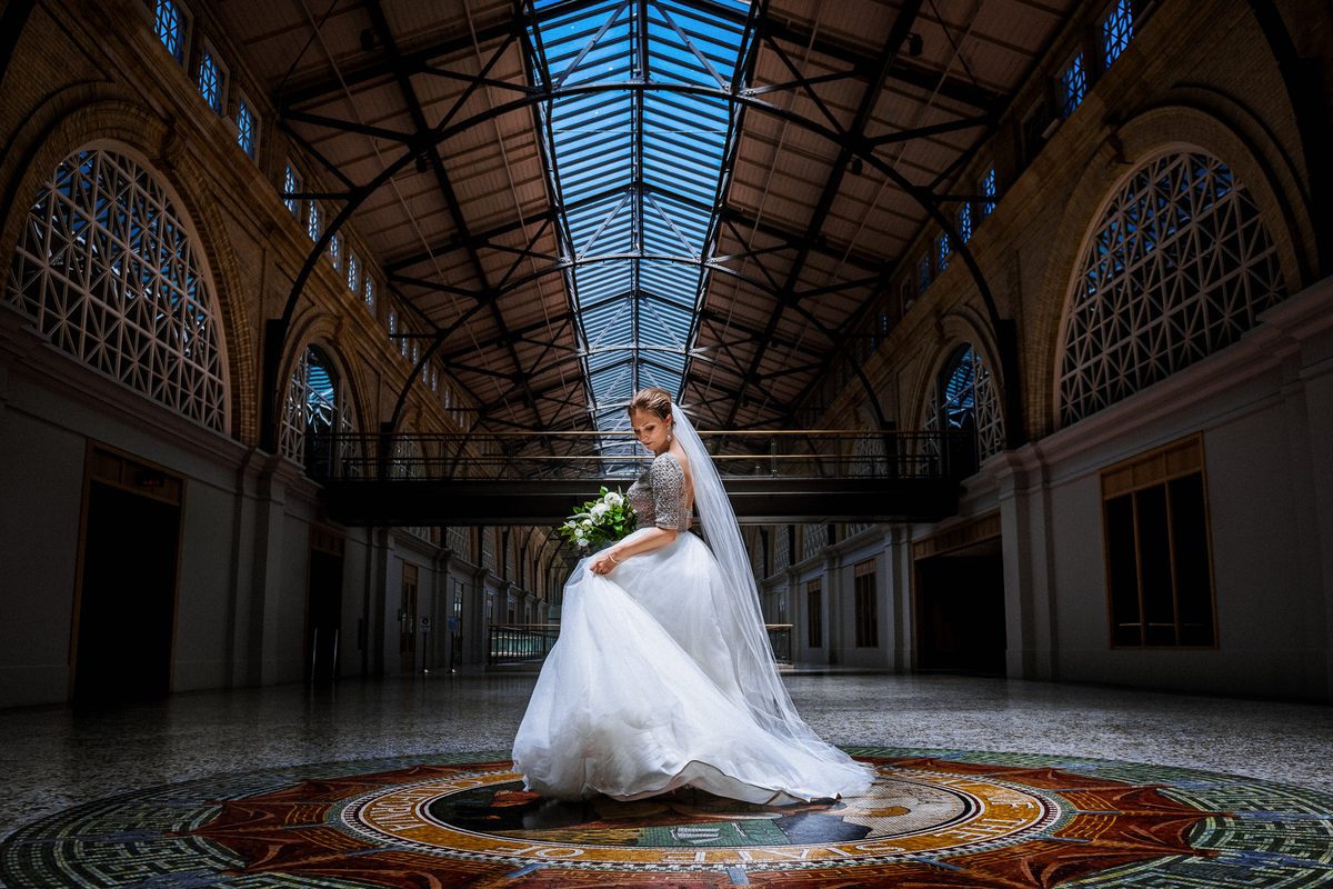 Bride beneath the ornate glass roof of the Ferry Building in San Francisco