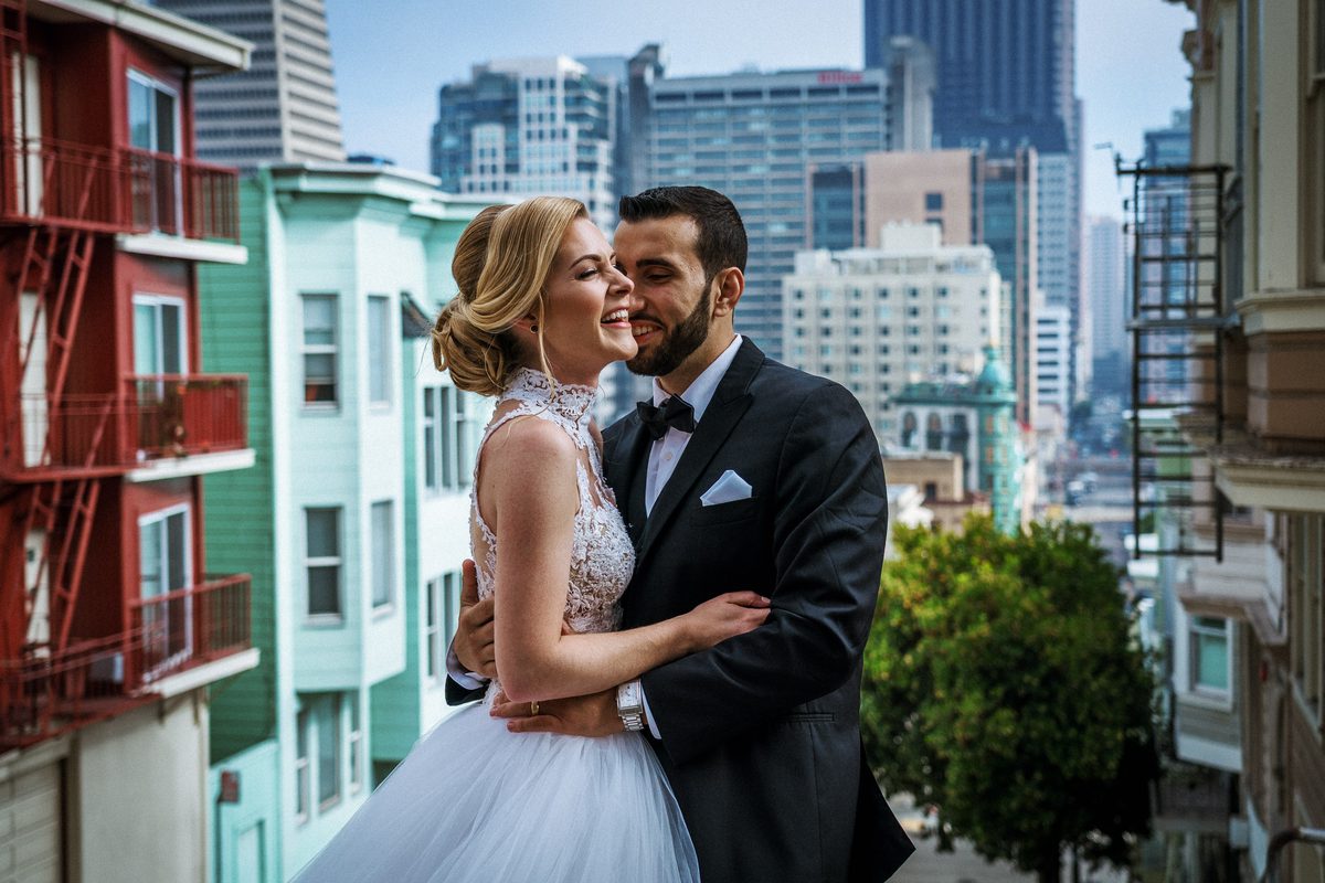 Laughing bride and groom during a North Beach wedding portrait session in San Francisco